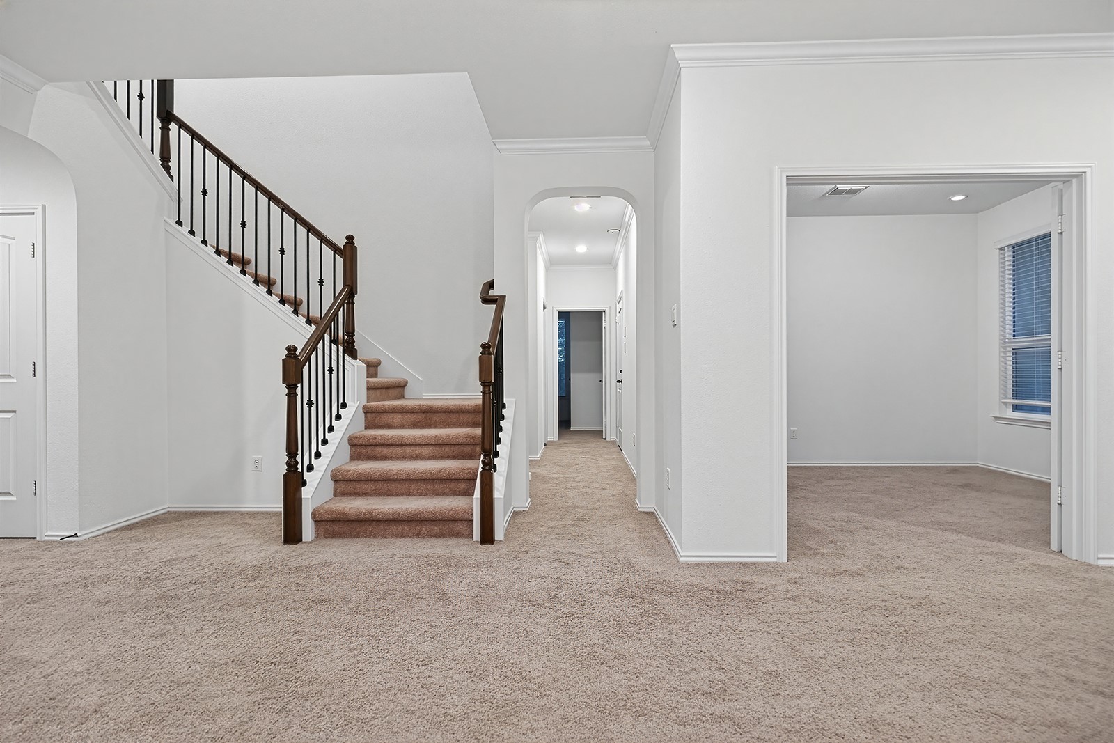 4600 Ercolano Lane Round Rock, TX 78665 - Photo 28 of 37 Central staircase with dark wood newel posts and black metal balusters