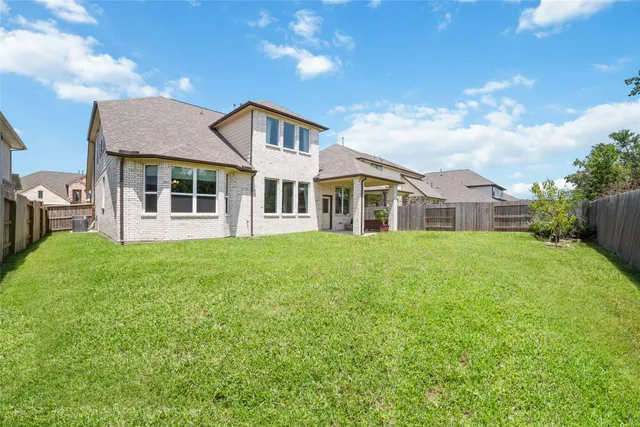 a front view of a house with a garden and plants