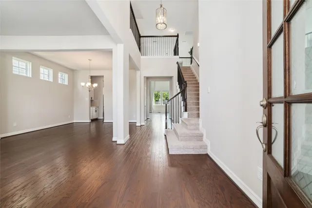 a view of a hallway view with wooden floor and staircase