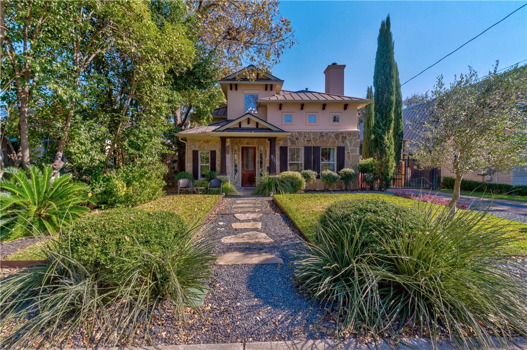 a front view of a house with a garden