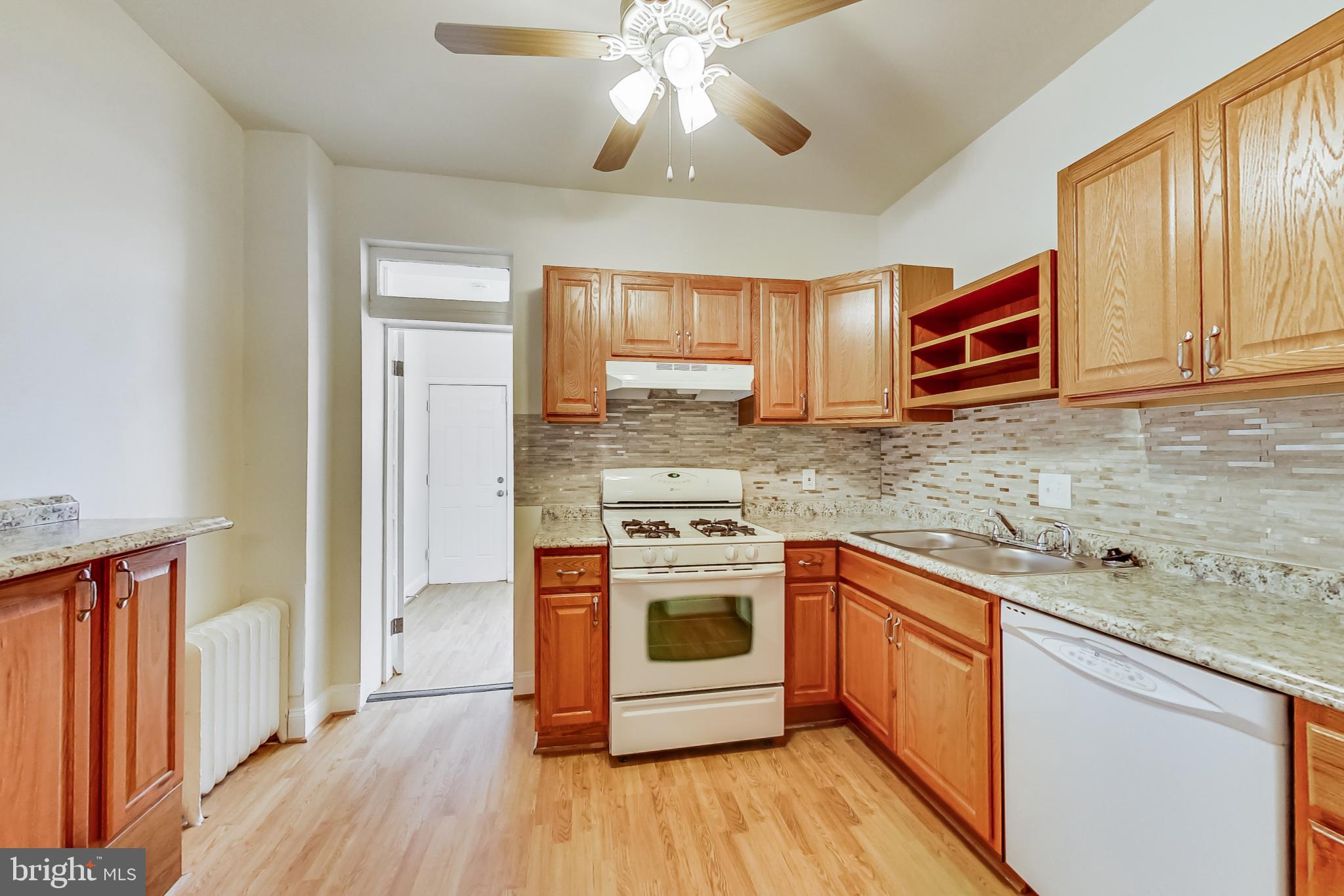 137 R Street Northeast Washington, DC 20002 - Photo 12 of 28 a kitchen with stainless steel appliances granite countertop a stove and a sink