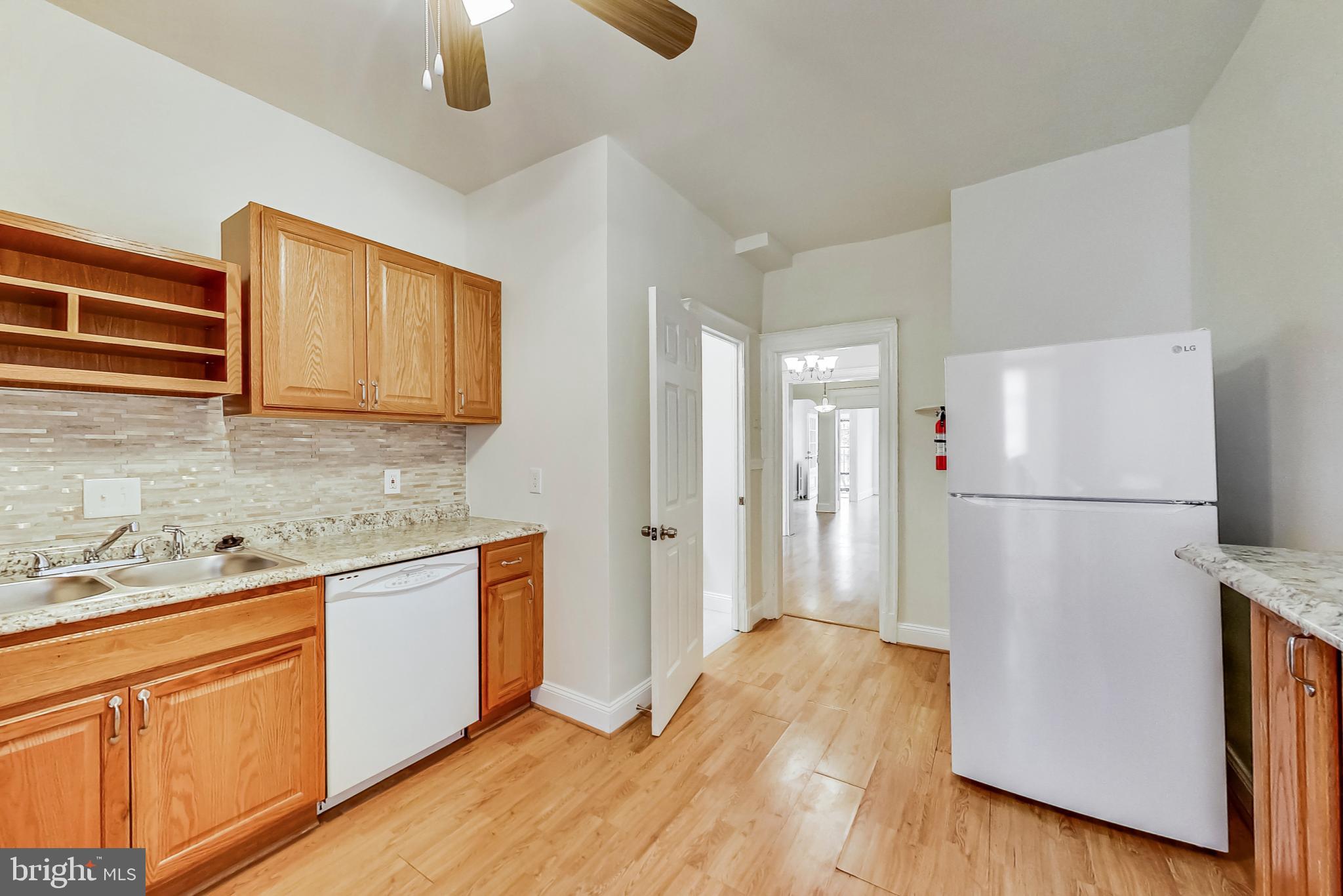 137 R Street Northeast Washington, DC 20002 - Photo 13 of 28 a kitchen with stainless steel appliances granite countertop a refrigerator a stove a sink a microwave oven with cabinets and wooden floor