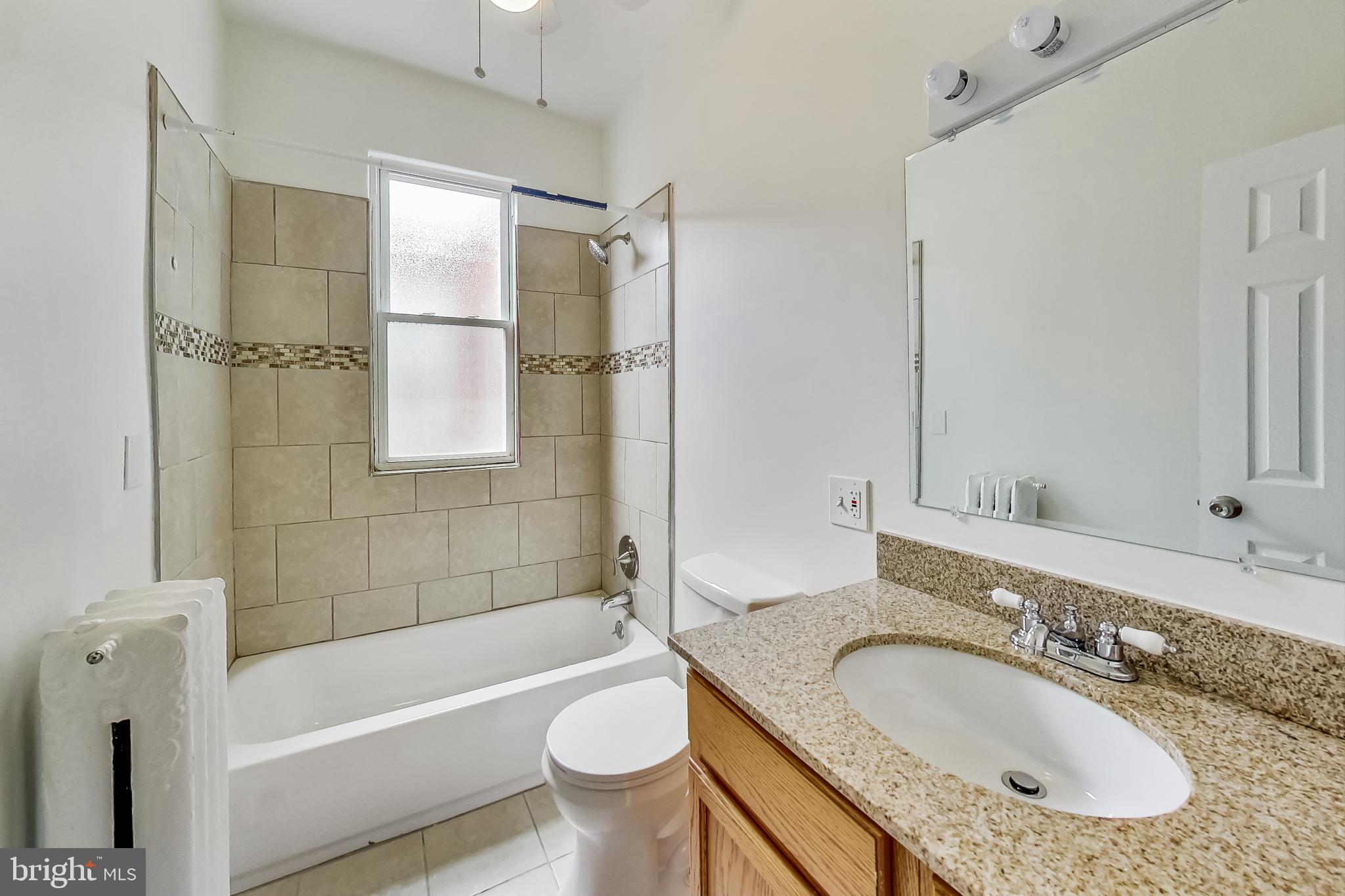 137 R Street Northeast Washington, DC 20002 - Photo 20 of 28 a bathroom with a granite countertop sink toilet and shower