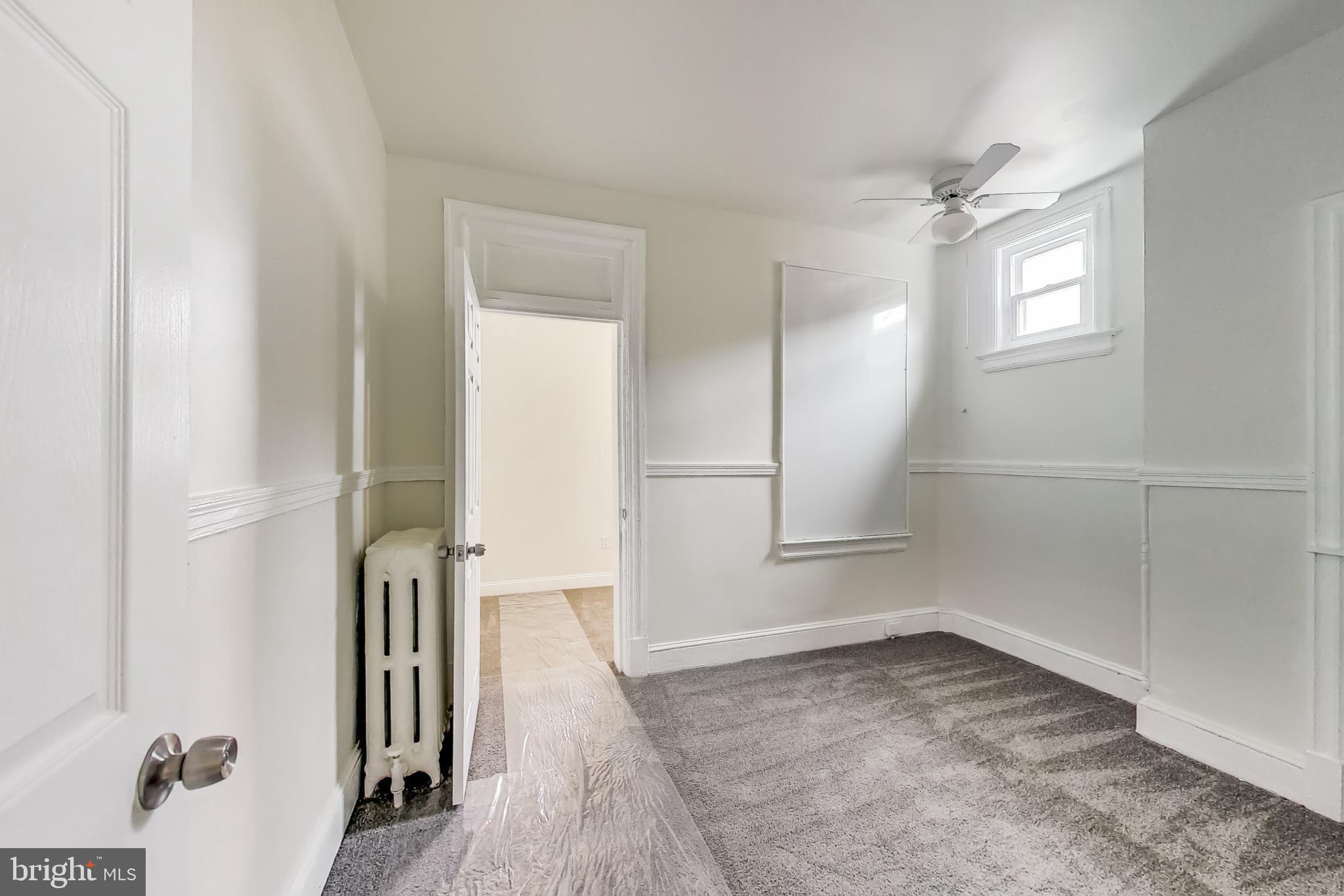 137 R Street Northeast Washington, DC 20002 - Photo 23 of 28 an empty room with wooden floor and a window