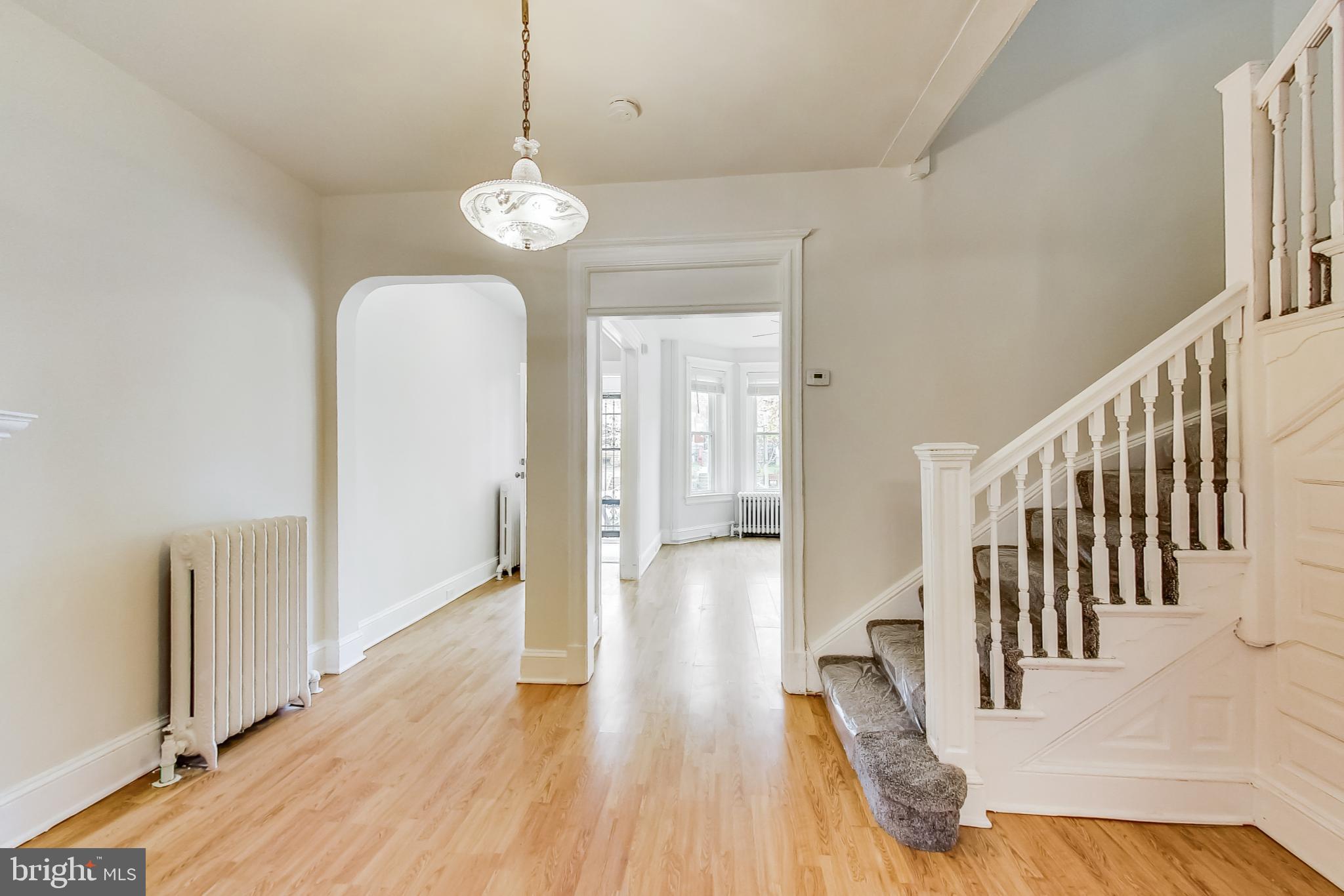 137 R Street Northeast Washington, DC 20002 - Photo 4 of 28 a view of a room with wooden floor staircase and a chandelier