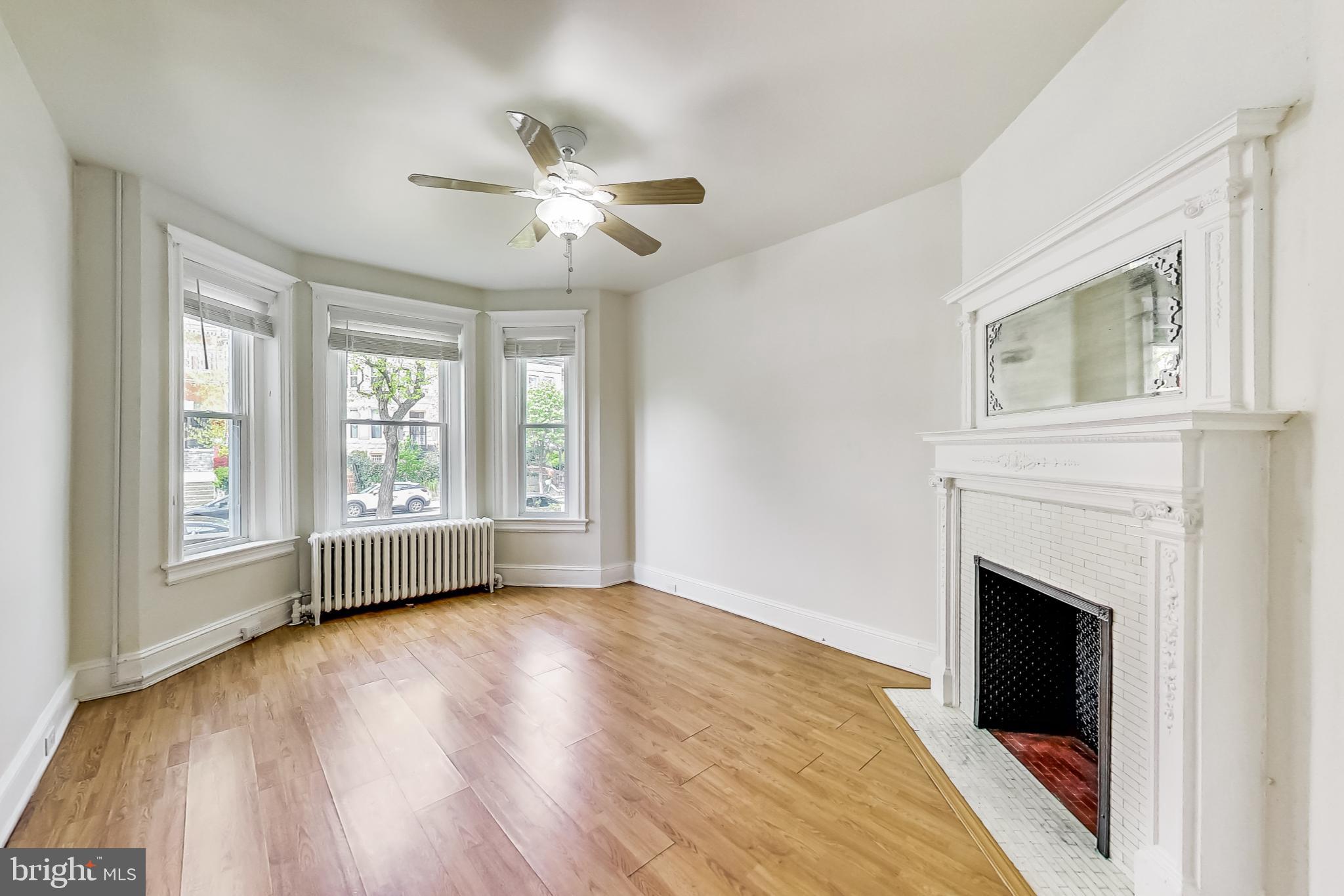 137 R Street Northeast Washington, DC 20002 - Photo 5 of 28 a view of an empty room with wooden floor and a window