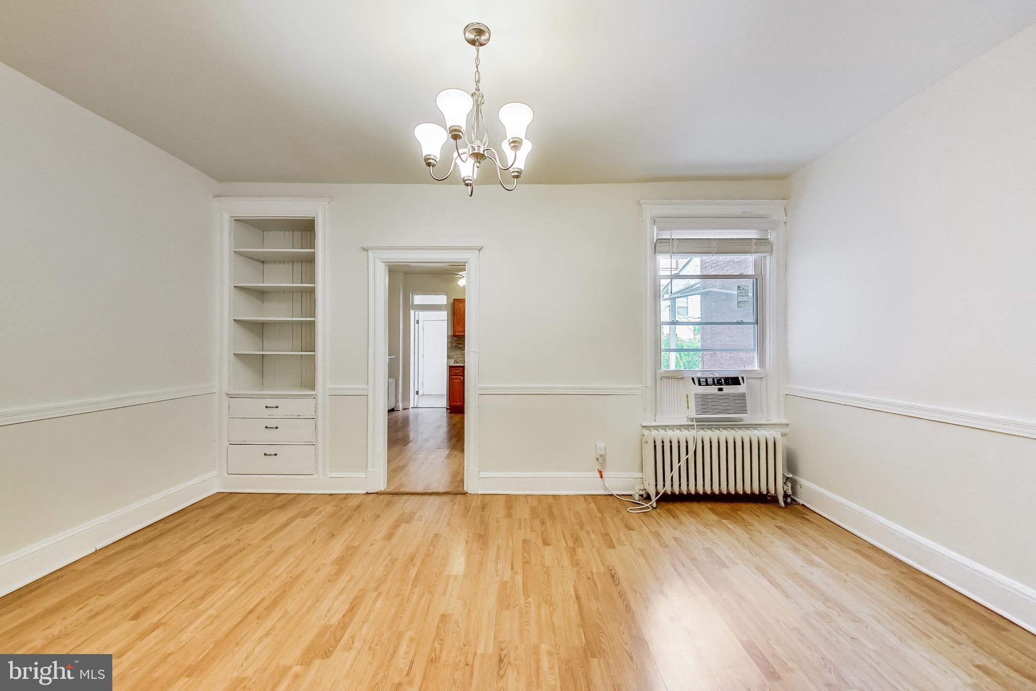 137 R Street Northeast Washington, DC 20002 - Photo 10 of 28 wooden floor in an empty room with a window