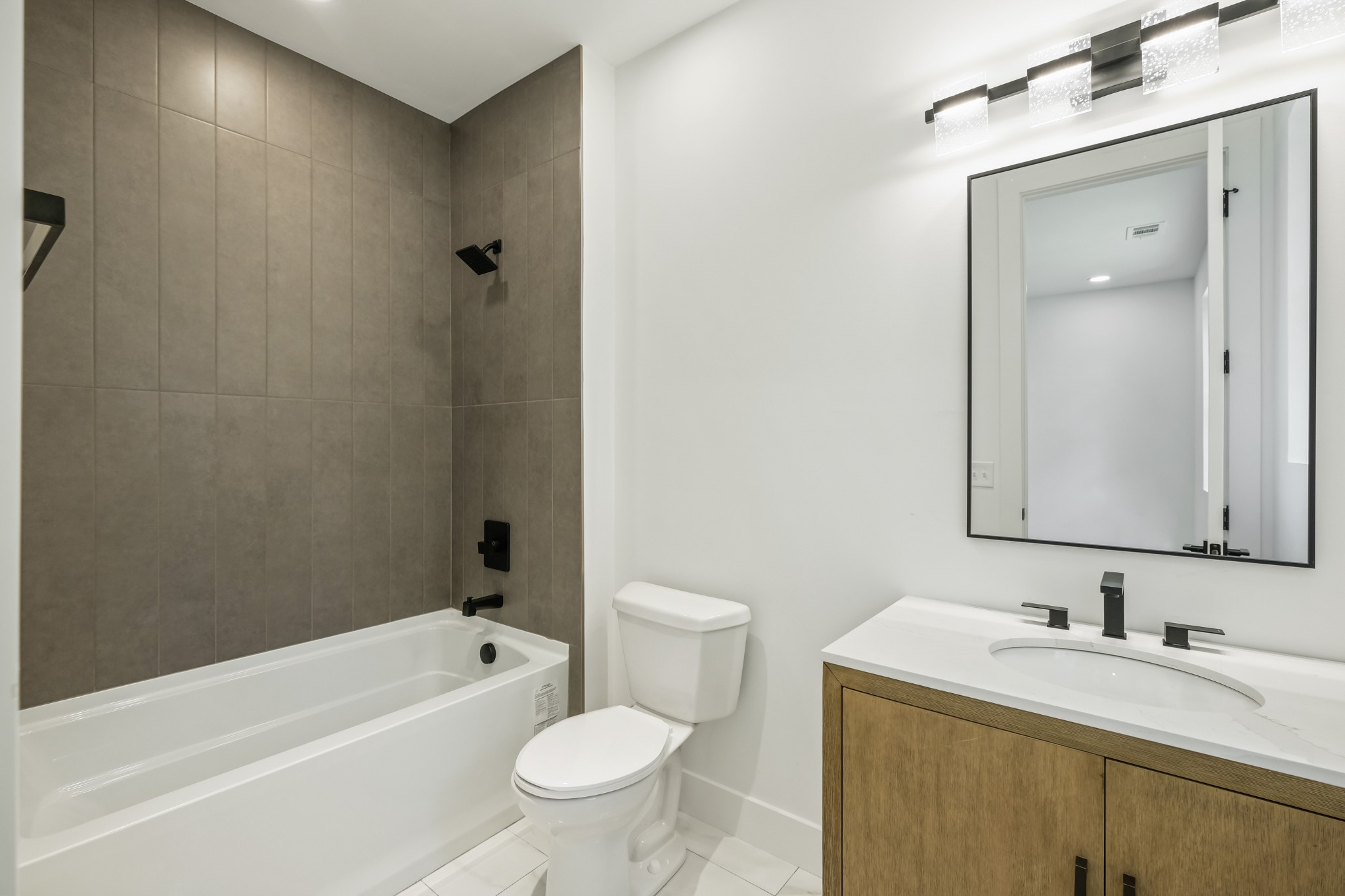 629 B Ries Avenue Nashville, TN 37209 - Photo 56 of 62 a bathroom with a toilet a sink a mirror a bathtub and vanity