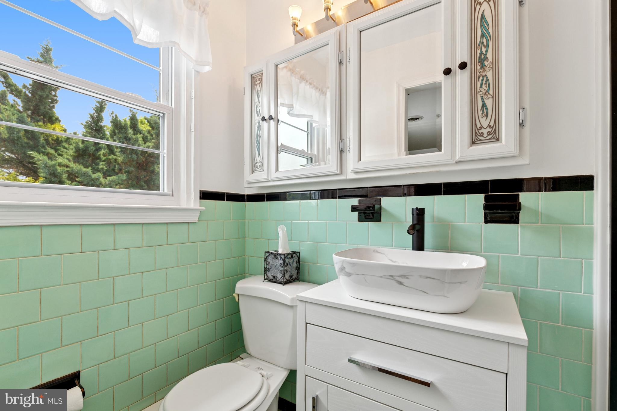 4009 High Point Road Ellicott City, MD 21042 - Photo 12 of 51 a bathroom with a toilet sink and mirror
