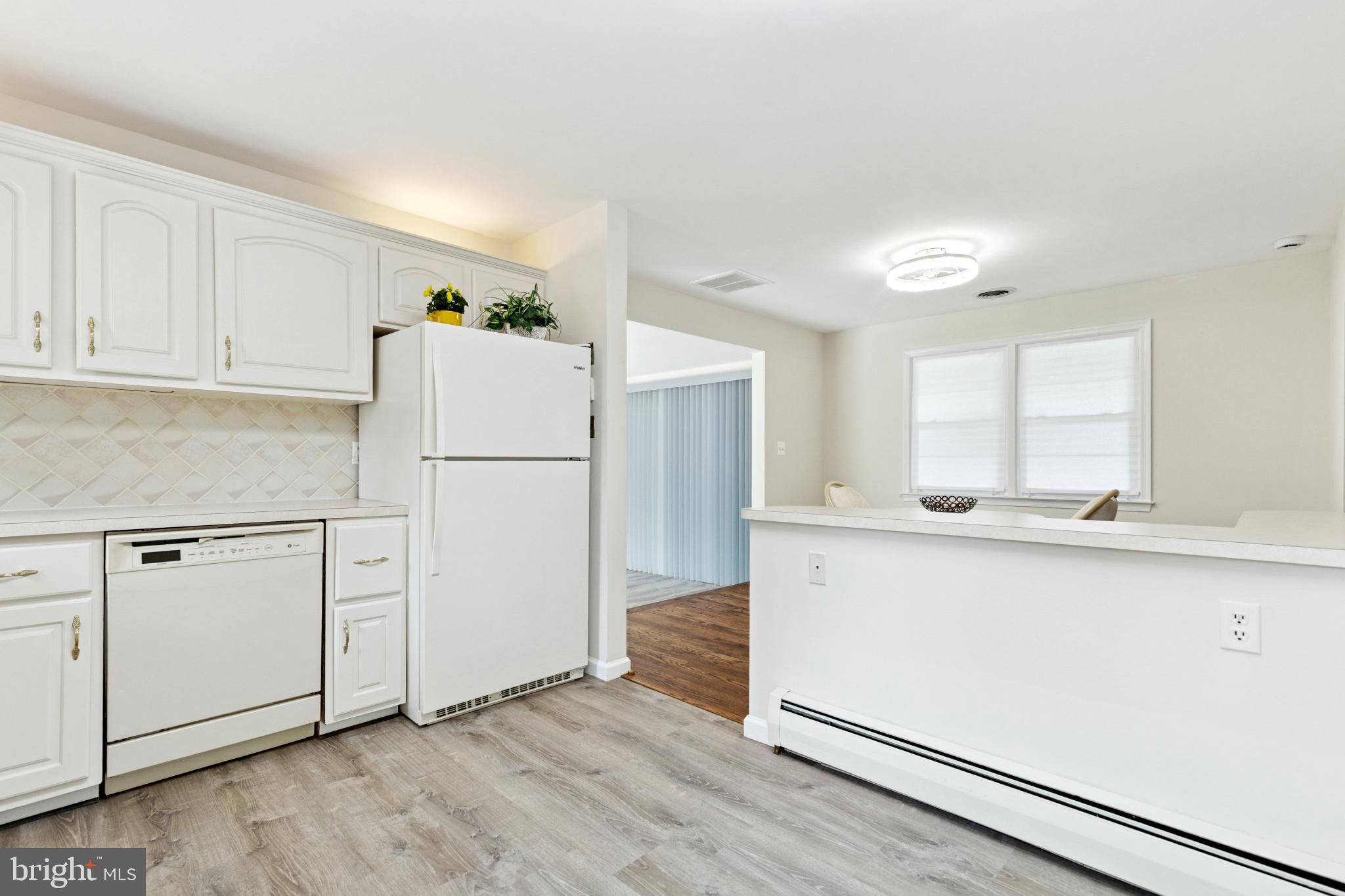 4009 High Point Road Ellicott City, MD 21042 - Photo 23 of 51 a kitchen with granite countertop white cabinets and refrigerator