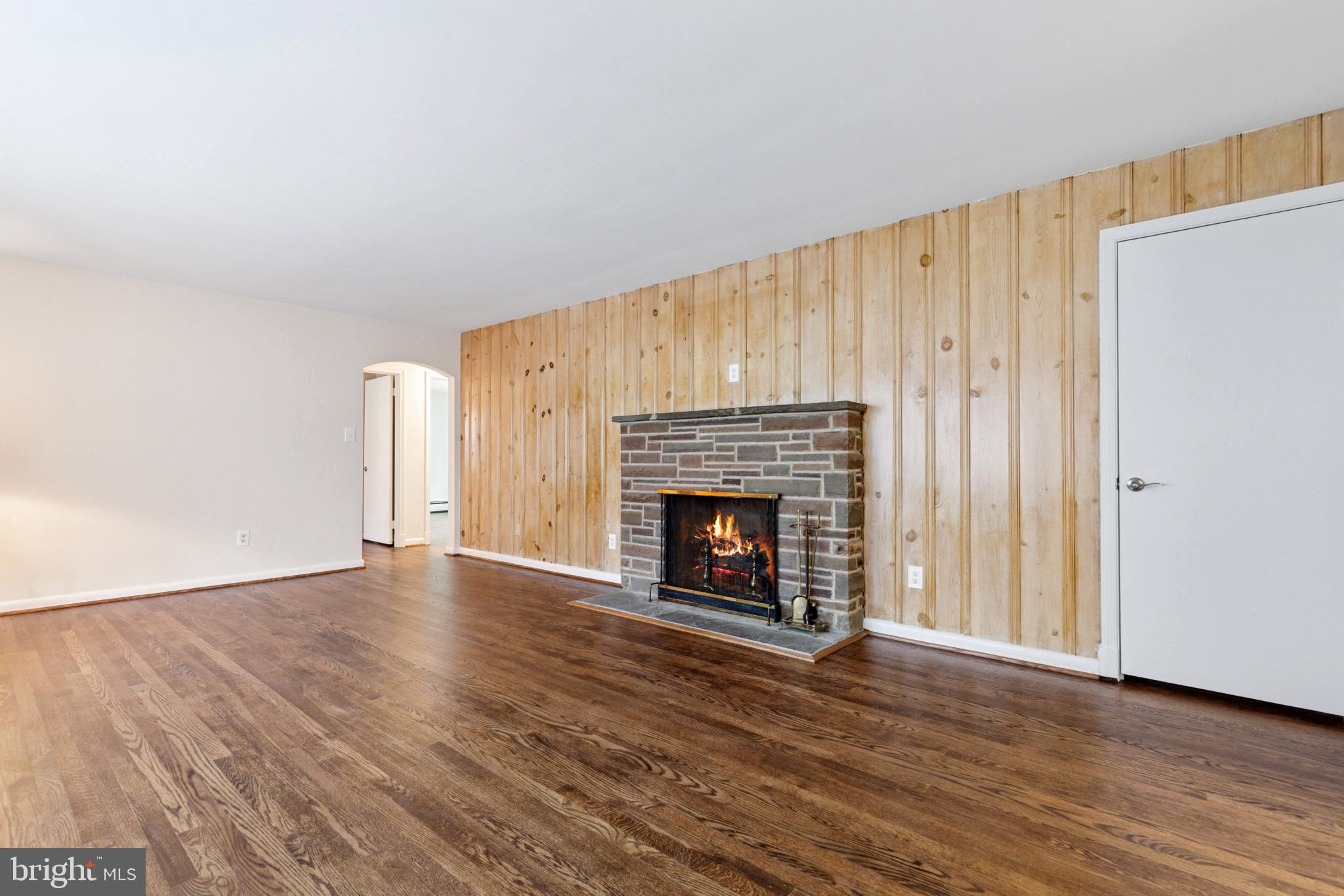 4009 High Point Road Ellicott City, MD 21042 - Photo 5 of 51 a view of an empty room with wooden floor fireplace and a window
