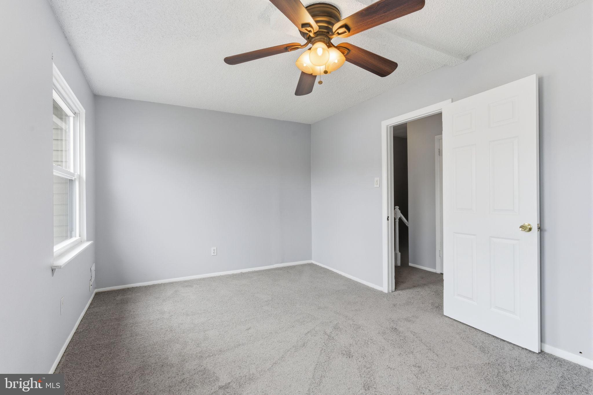 393 Rutgers Court Bensalem, PA 19020 - Photo 11 of 21 an empty room with closet and a ceiling fan