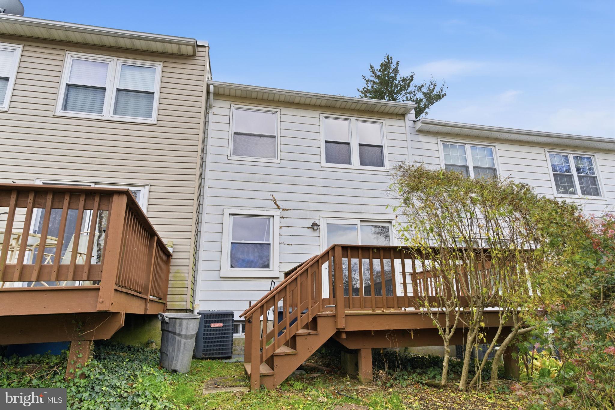 393 Rutgers Court Bensalem, PA 19020 - Photo 16 of 21 a view of a house with a small yard and deck of a house