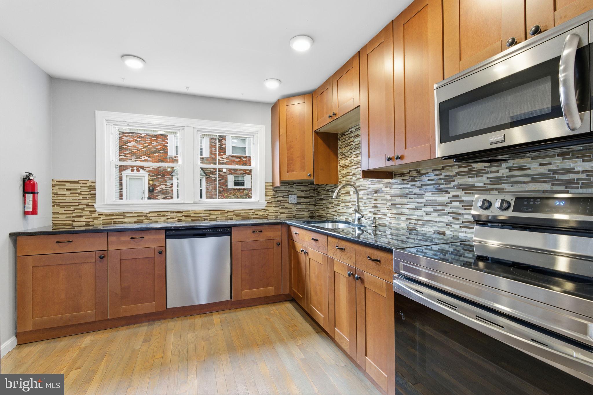 393 Rutgers Court Bensalem, PA 19020 - Photo 2 of 21 a kitchen with stainless steel appliances granite countertop wooden cabinets a sink and dishwasher