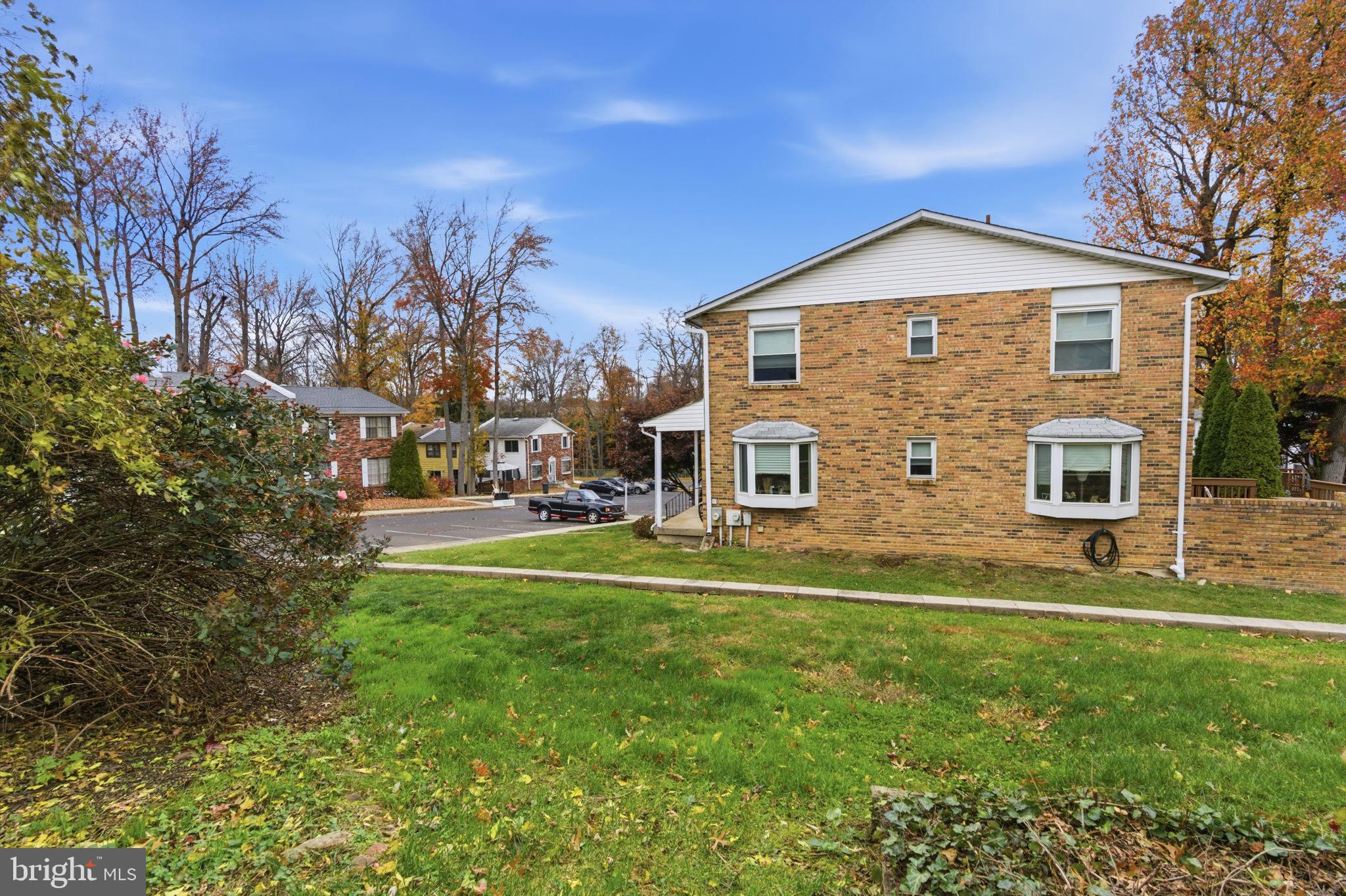 393 Rutgers Court Bensalem, PA 19020 - Photo 21 of 21 a front view of house with yard and trees in the background