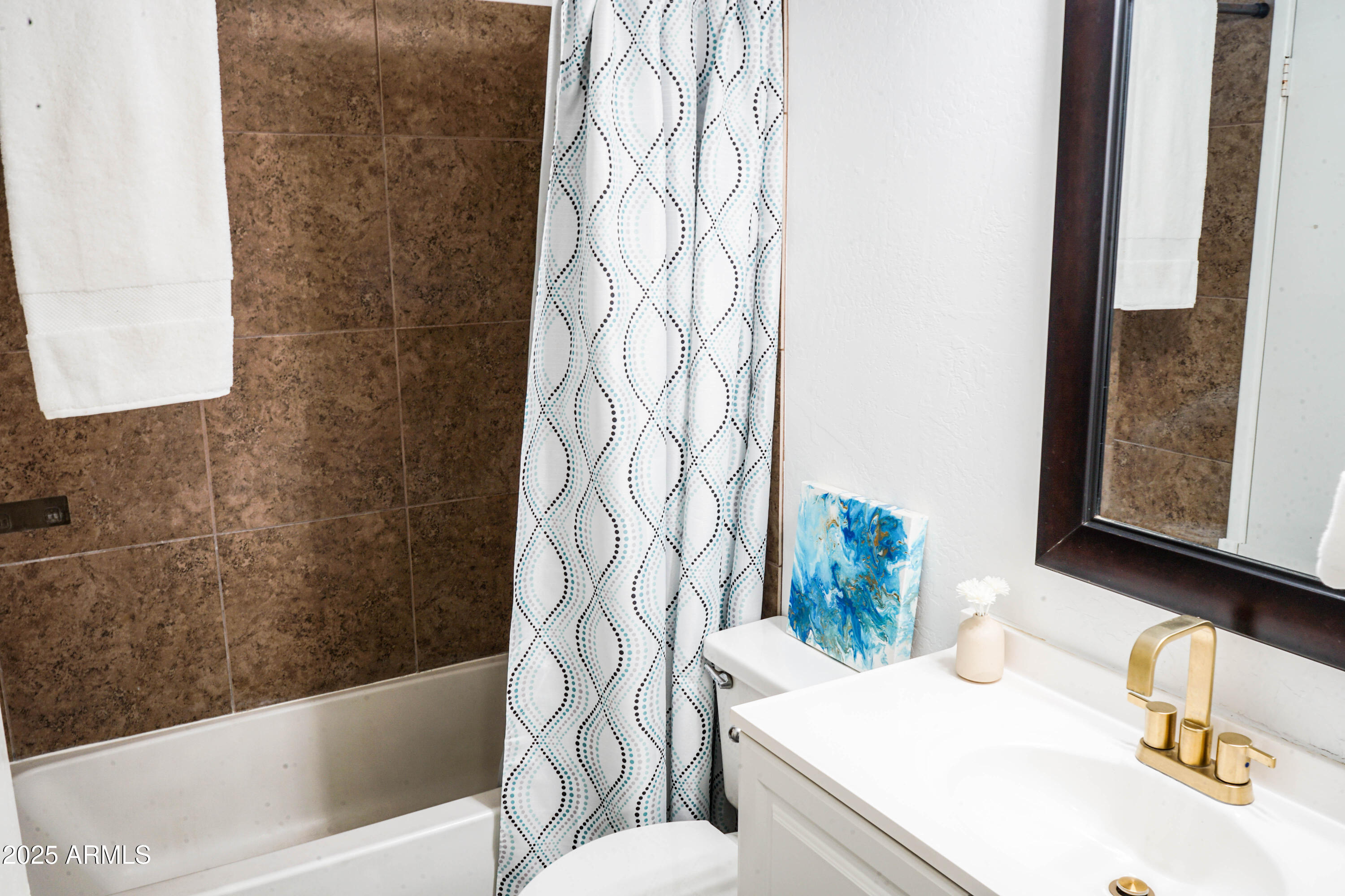 1126 West Elliot Road, Unit 1066 Chandler, AZ 85224 - Photo 13 of 21 a bath room with a sink and a mirror