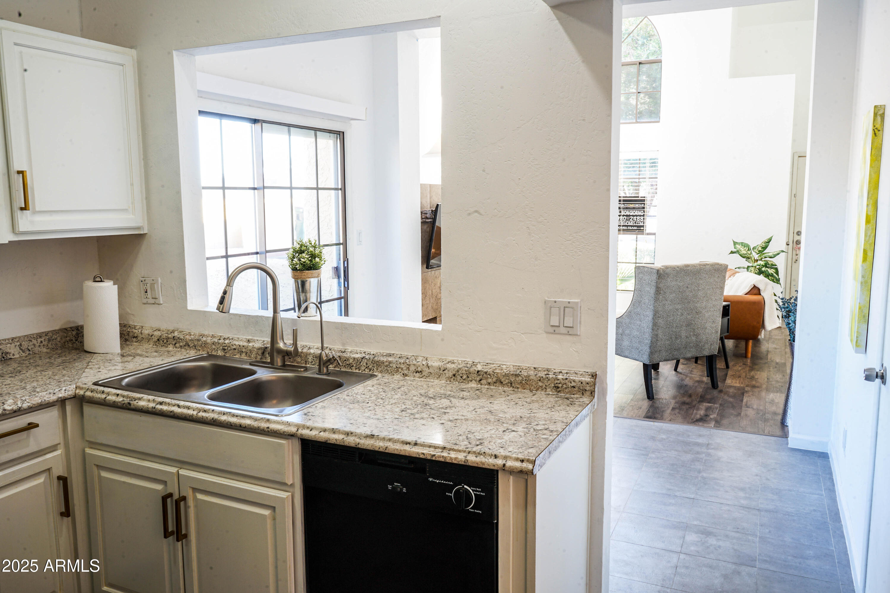 1126 West Elliot Road, Unit 1066 Chandler, AZ 85224 - Photo 17 of 21 a kitchen with granite countertop a sink and a window