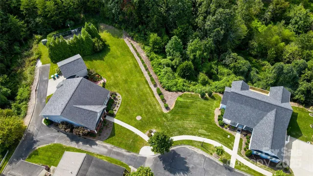 an aerial view of a house with a garden and trees