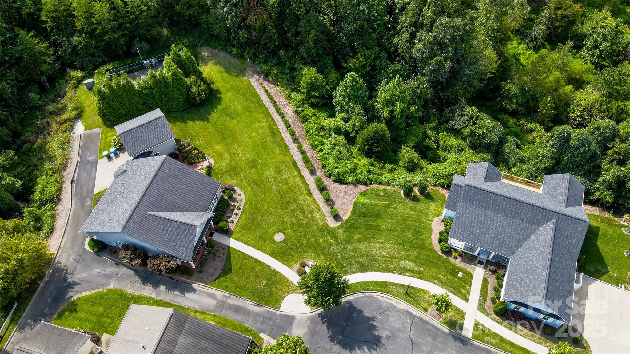 13264 Old Compton Court, Unit 45 Pineville, NC 28134 - Photo 4 of 12 an aerial view of a house with a garden and trees