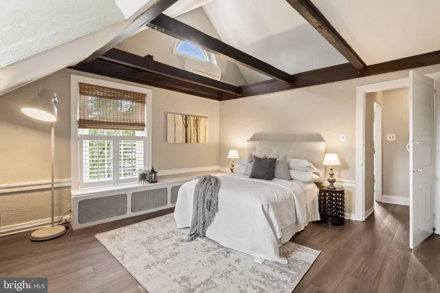 a bedroom with bed and a window