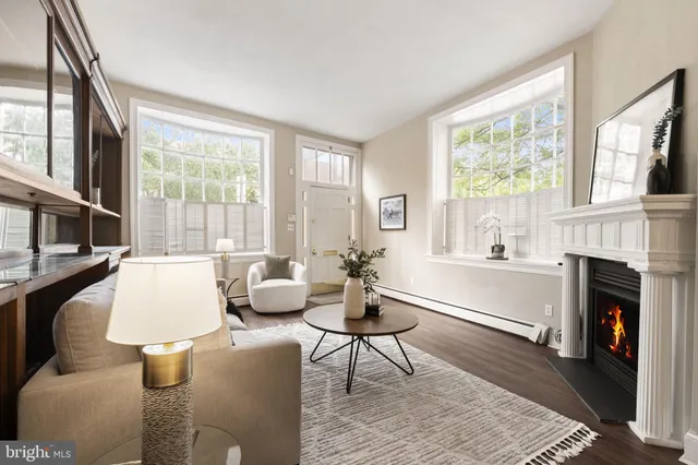 a living room with fireplace furniture and a large window