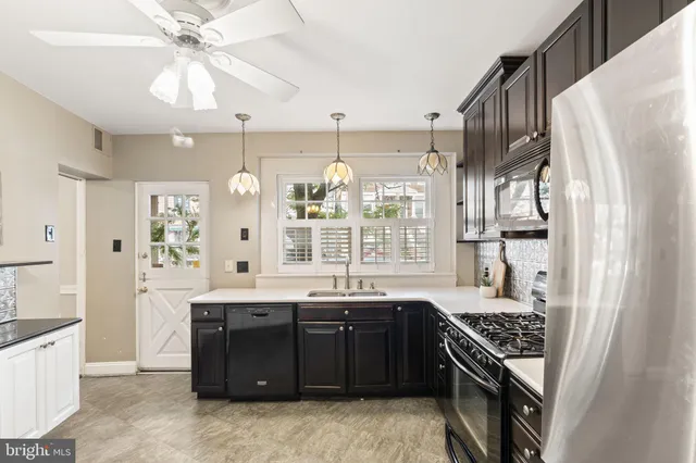 a large kitchen with granite countertop a stove and a refrigerator