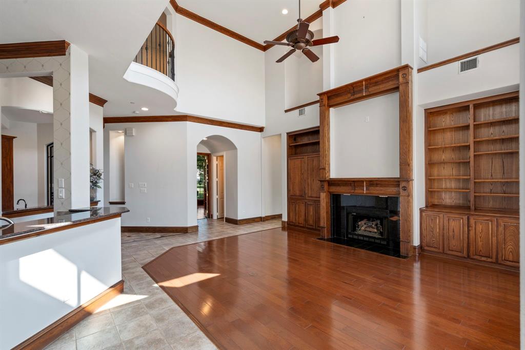 1000 Saddlebrook Drive Lucas, TX 75002 - Photo 13 of 39 Main Living room with a towering ceiling, crown molding, a fireplace with built-ins, a ceiling fan, and recessed lighting