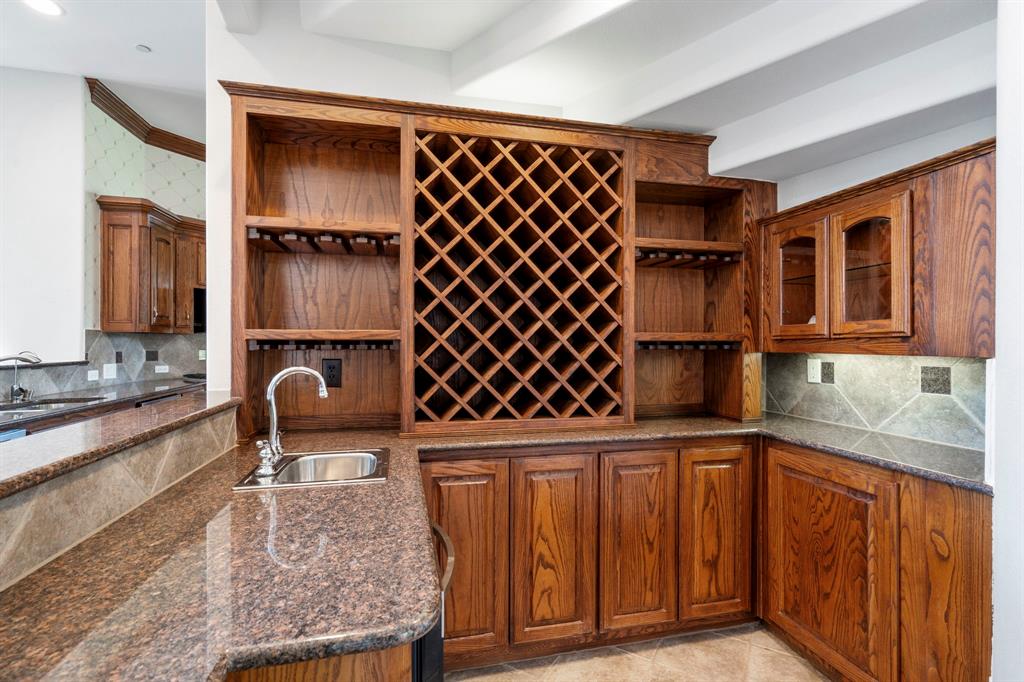 1000 Saddlebrook Drive Lucas, TX 75002 - Photo 16 of 39 Wine bar with sink featuring, Wrought iron doors wine fridge and wine storage for reds