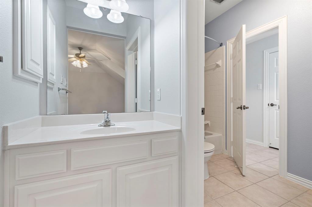 1000 Saddlebrook Drive Lucas, TX 75002 - Photo 33 of 39 Jack'n Jill bath featuring light tile patterned flooring, bathing tub / shower combination, vanity,