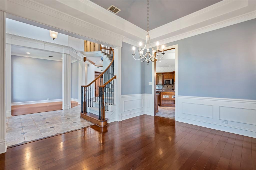 1000 Saddlebrook Drive Lucas, TX 75002 - Photo 9 of 39 Dining area featuring dark wood finished floors, a tray ceiling, stairway, and crown molding