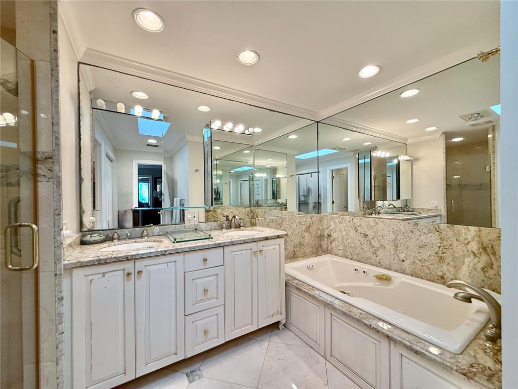 869 Robin Lane Sebastian, FL 32958 - Photo 14 of 35 a bathroom with a granite countertop sink mirror and bathtub