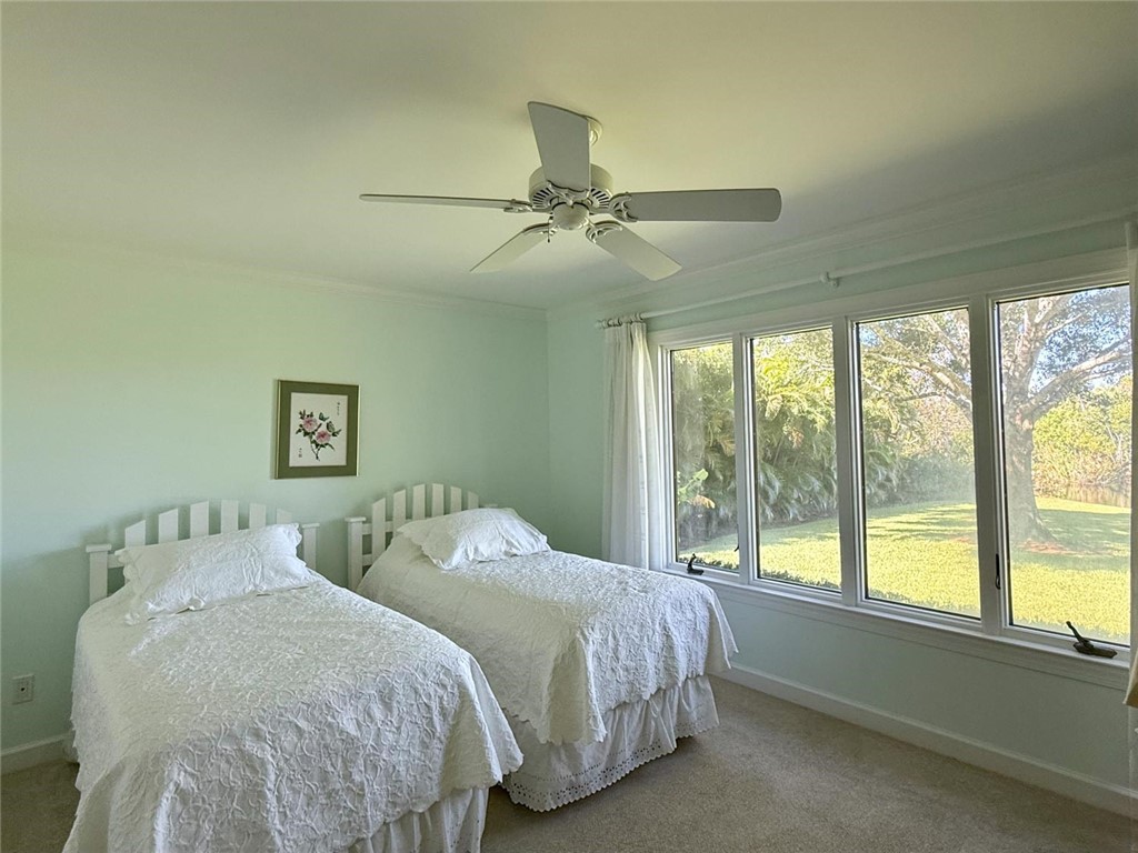 869 Robin Lane Sebastian, FL 32958 - Photo 16 of 35 a bedroom with two beds and a large window