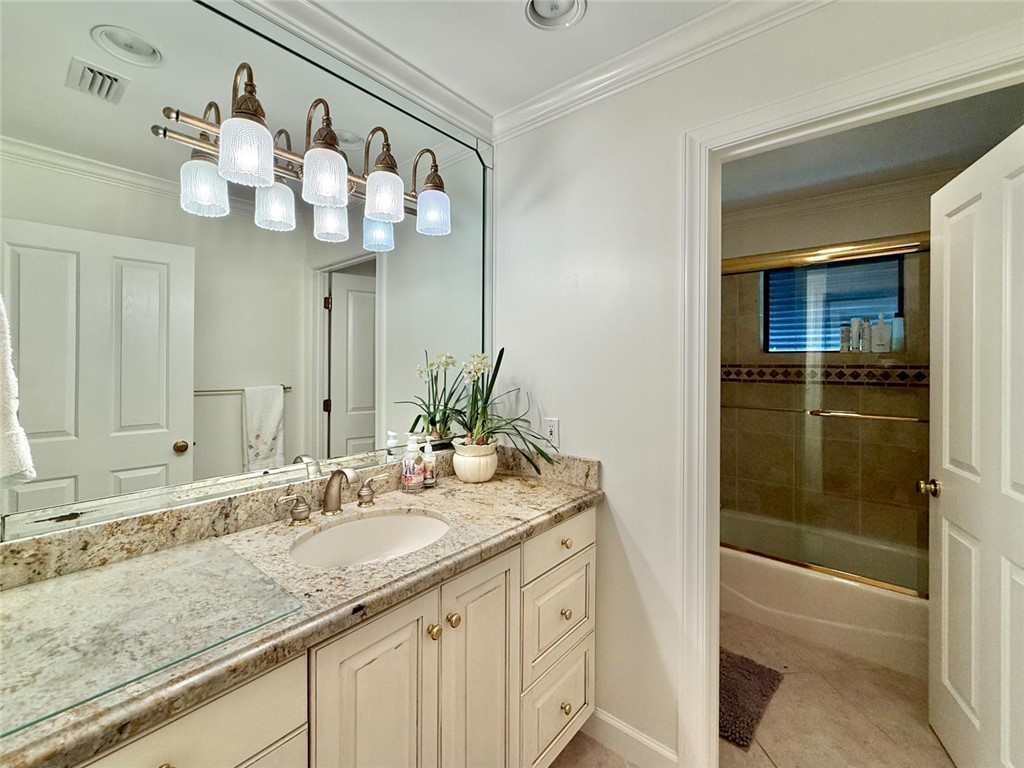 869 Robin Lane Sebastian, FL 32958 - Photo 17 of 35 a bathroom with a sink vanity granite tub and shower