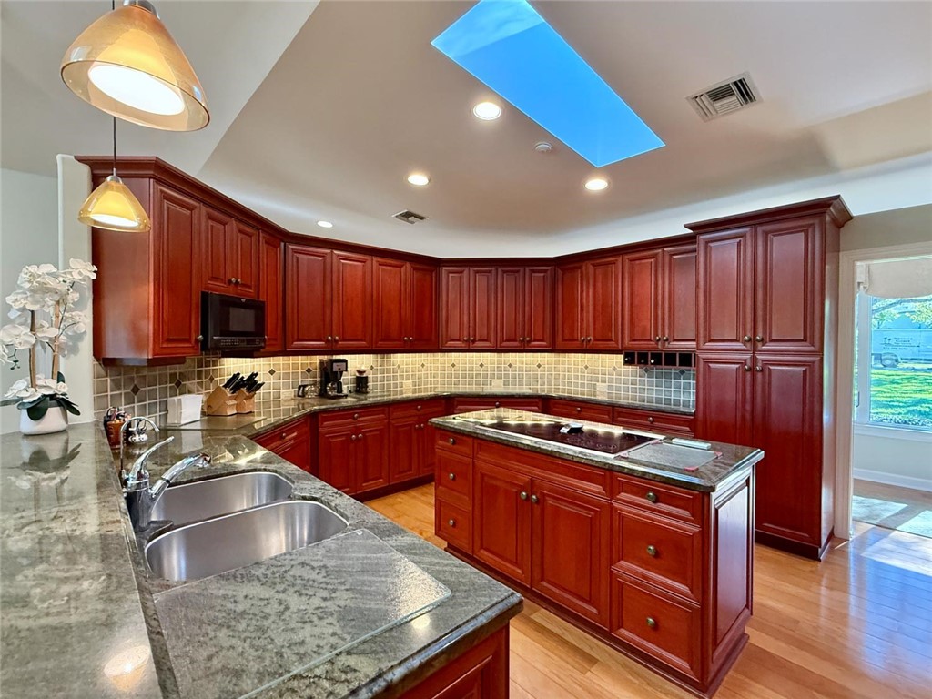 869 Robin Lane Sebastian, FL 32958 - Photo 18 of 35 a kitchen with wooden cabinets a sink a stove and a window