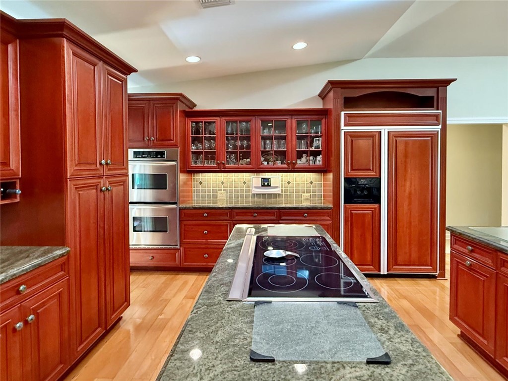 869 Robin Lane Sebastian, FL 32958 - Photo 20 of 35 a kitchen with stainless steel appliances granite countertop a refrigerator a stove and a wooden cabinets