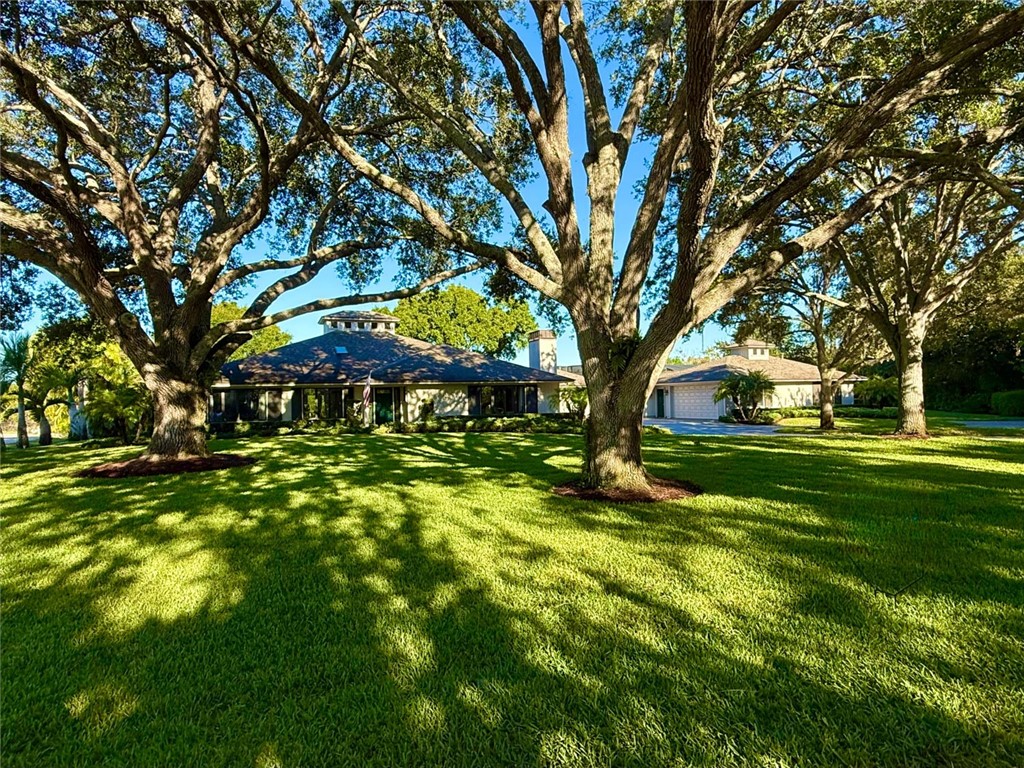 869 Robin Lane Sebastian, FL 32958 - Photo 2 of 35 a backyard of a house with lots of green space