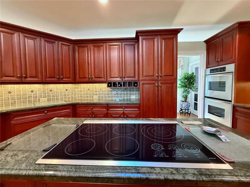 869 Robin Lane Sebastian, FL 32958 - Photo 21 of 35 a kitchen with wooden cabinets stove and refrigerator