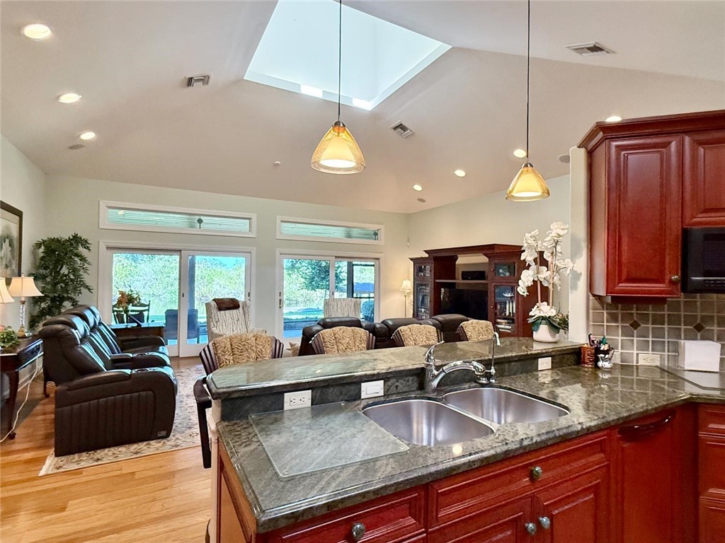 869 Robin Lane Sebastian, FL 32958 - Photo 22 of 35 a kitchen with granite countertop a sink a counter space appliances and cabinets