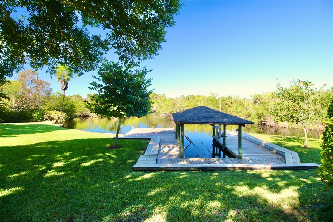 869 Robin Lane Sebastian, FL 32958 - Photo 32 of 35 a view of a swimming pool with lawn chairs under an umbrella