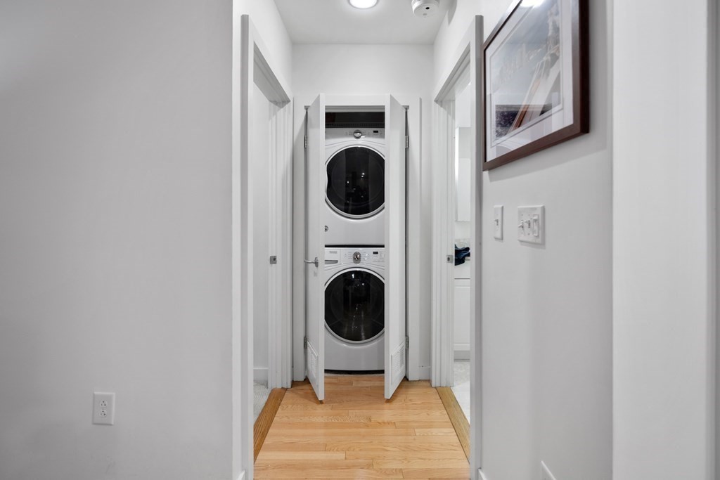 80 Broad Street, Unit 203 Boston, MA 02110 - Photo 8 of 21 a view of a hallway with washer and dryer