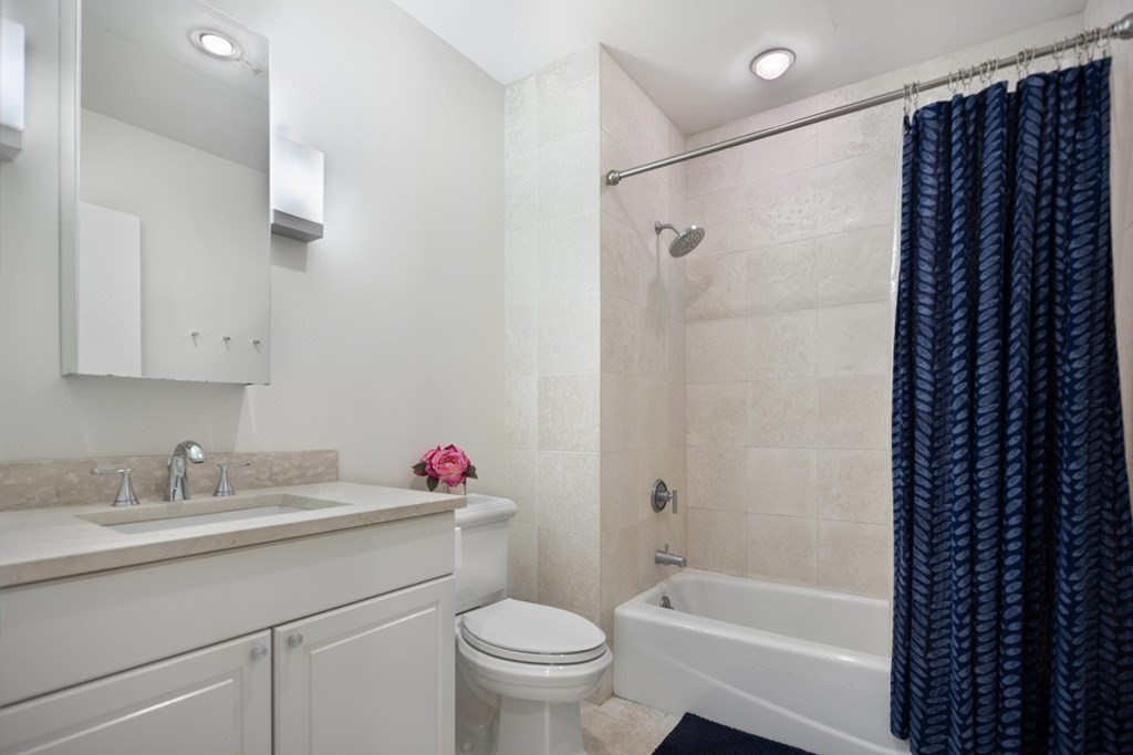 80 Broad Street, Unit 203 Boston, MA 02110 - Photo 9 of 21 a bathroom with a sink toilet and shower