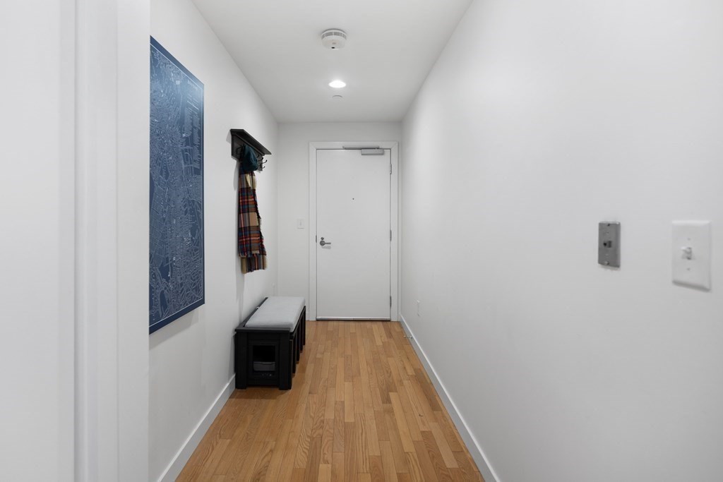 80 Broad Street, Unit 203 Boston, MA 02110 - Photo 10 of 21 a view of hallway with stairs and wooden floor