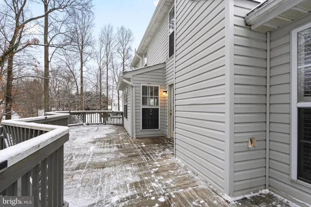 a view of a patio with a table and chairs and a barbeque