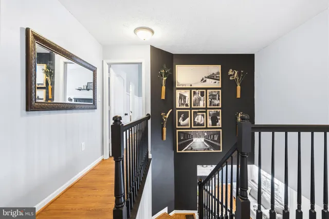 a view of a hallway with wooden floor and entryway
