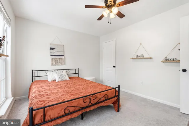 a bed sitting in a bedroom next to a window