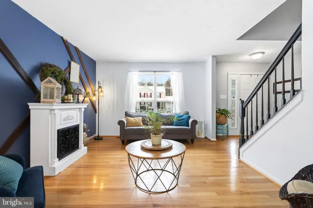 a living room with furniture a fireplace and a large window