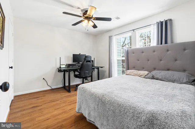 a bedroom with a bed dresser and a window