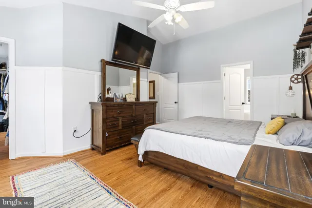 a bedroom with a bed and flat screen tv