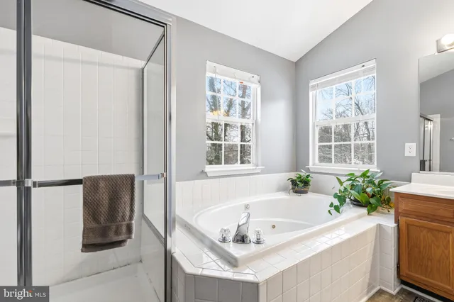 a bath tub sitting in a bathroom next to a window