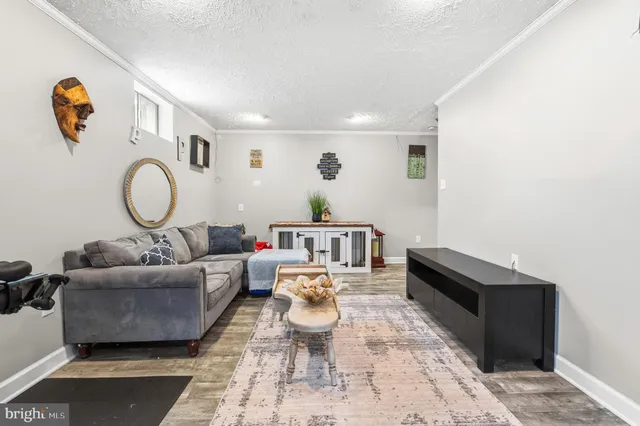 a living room with furniture and a mirror